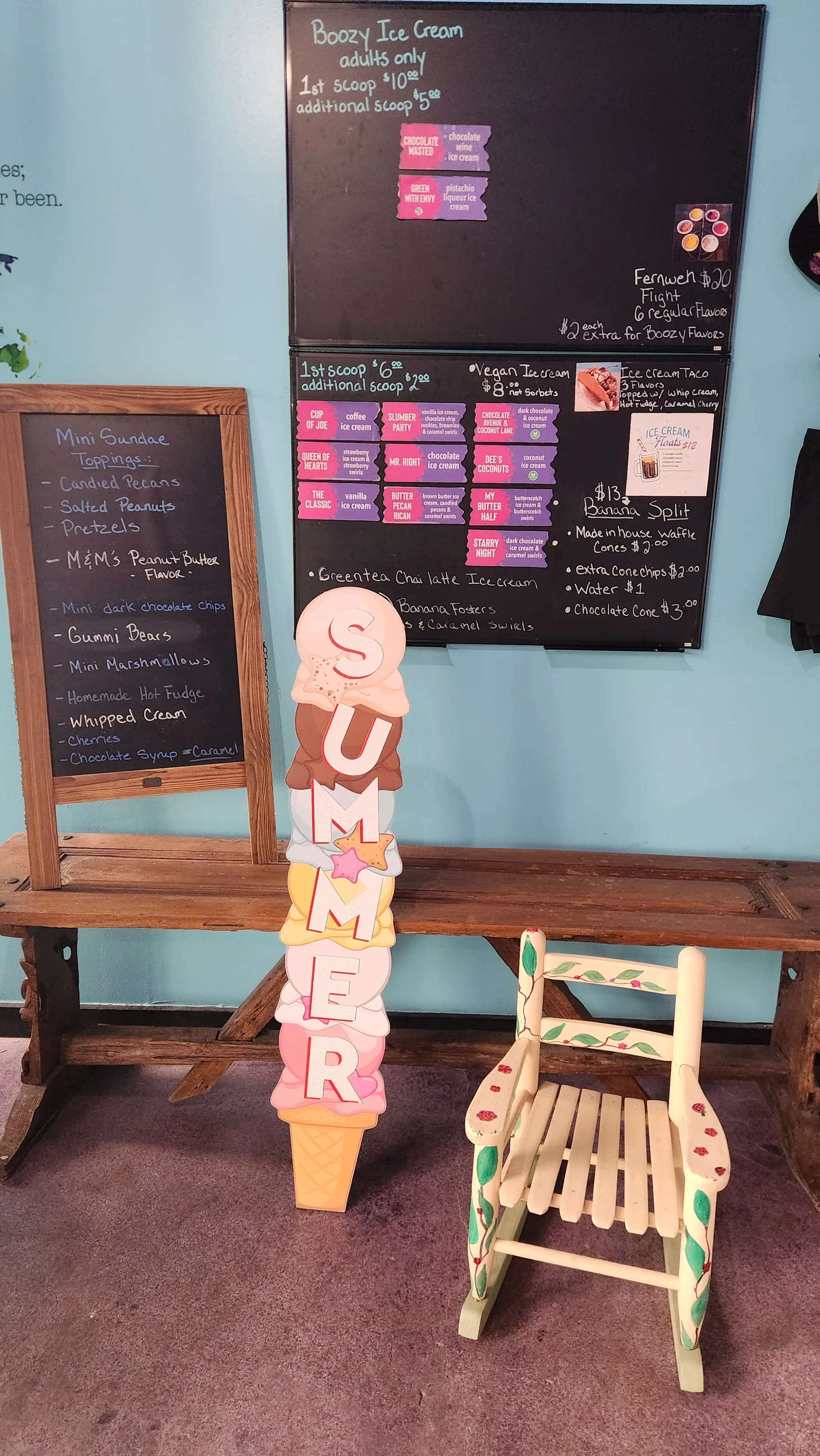 Inside the shop — chalkboards, a SUMMER ice-cream-cone cutout, and a hand-painted ice cream chair
