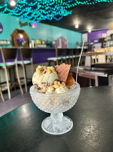 Sundae in a crystal coupe with peanuts and waffle cone shards